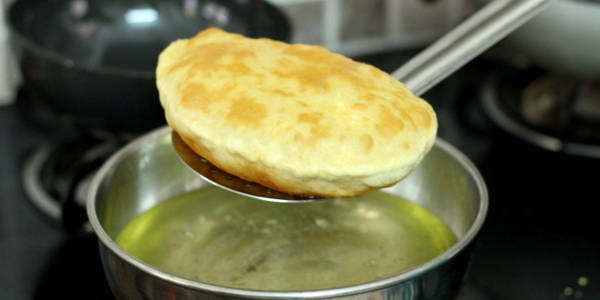 Bhature Recipe for Chole Bhature taking out the puri