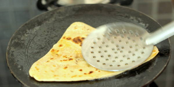 Jeera Paratha Recipe press using  spoon