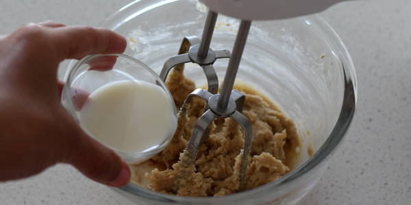 eggless Chocolate Chips Cookie adding milk and beeting